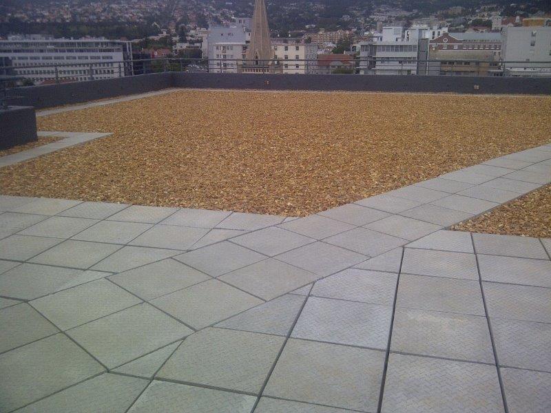 Roof
                  deck waterproofing with enhanced sidewall outlets.
                  Perimeter channel / loose lay paving on support rings
                  with ballast cover